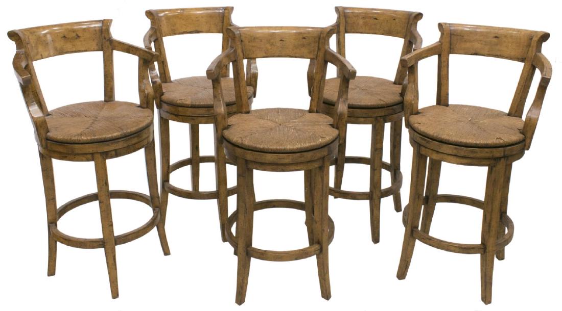 (5) RUSTIC SWIVELING RUSH SEAT BARSTOOLS: (set of 5) Rustic barstools, each having back rest and short arms, joined to swivel rush seat, on a stretcher base, approx 42"h, 19.5"w, 19"d, seat height: approx 28.25 Start Price: $100.00
