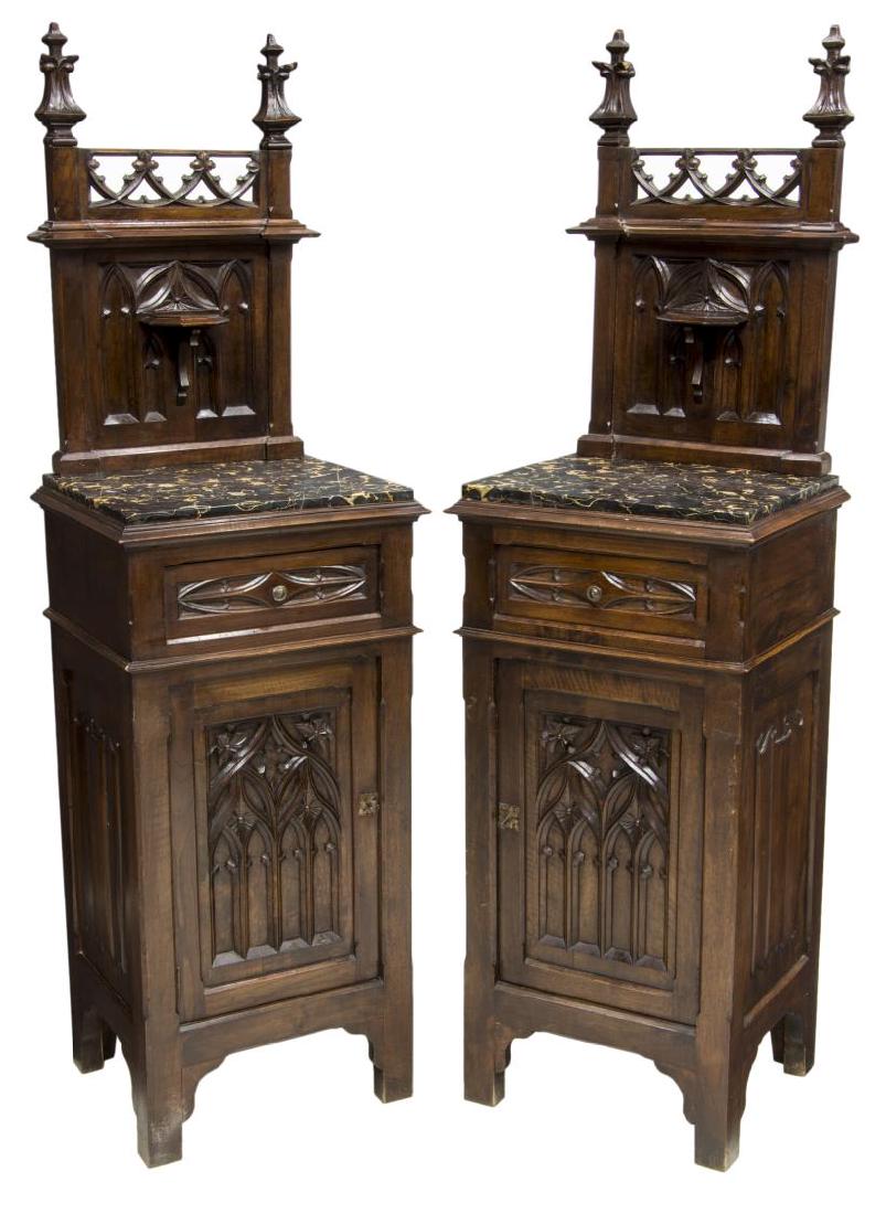 (PAIR) GOTHIC STYLE MARBLE TOP BEDSIDE CABINETS: (pair) Gothic style bedside cabinets, late 19th c., accented with carved spires, tracery and linen fold, a tall back above the inset marble top, a single drawer over a door, rising on shaped supports,
