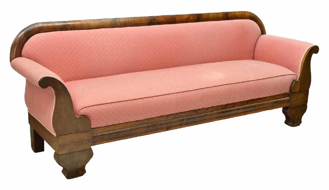 BIEDERMEIER MAHOGANY FRAME SOFA: Empire mahogany veneer sofa, pink diamond pattern upholstery, a shaped back over bolster arms, rising on shaped bracket feet, old repairs to veneer, approx 31.5"h, 82.75"w, 24"d Start Price: $200.00