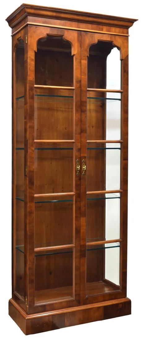 FINE HENREDON LIGHTED GLASS DISPLAY/ CHINA CABINET: Henredon lighted display/ china cabinet, in a cherrywood finish, having cornice top, over double doors, doors and side panels set with beveled glass panes, rising on plinth base, approx 84"h, 32"w, 14