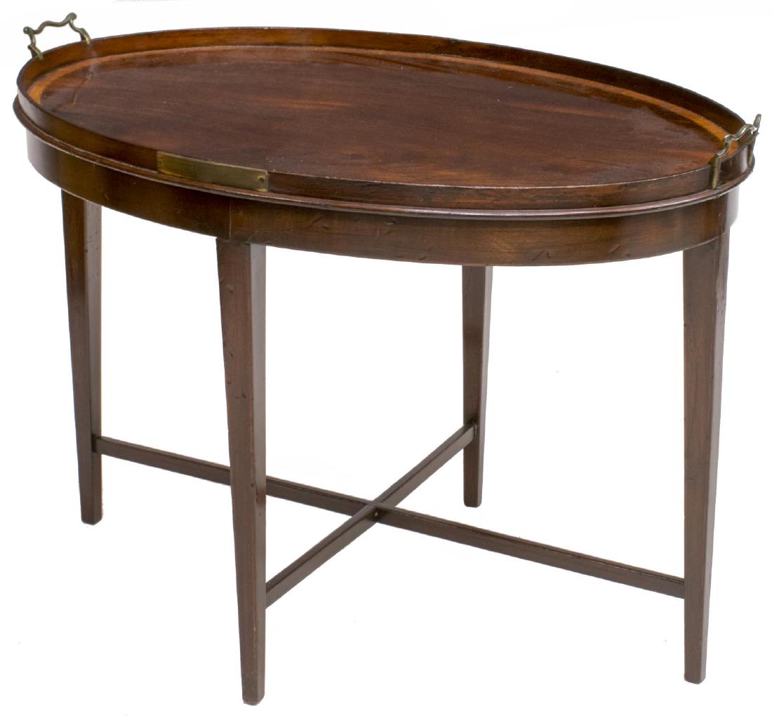 OVAL HARDWOOD COFFEE TABLE, FAUX TRAY TOP: Oval hardwood coffee table, having recessed top, with brass handles to either end, rising on stretcher joined square tapered legs, approx 21.25"h, 30.75"w, 20.75"d Start Price: $80.00