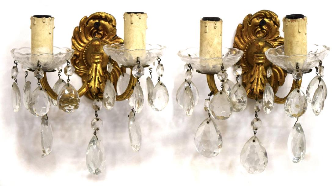 (PAIR) CONTINENTAL LOUIS XV GILT BRONZE SCONCES: (pair) Continental Louis XV style bronze and crystal two-light sconces, 20th c., gilt bronze foliate pattern base issuing two scrolled arms holding glass bobeche, faux candle sticks, hung with cut and