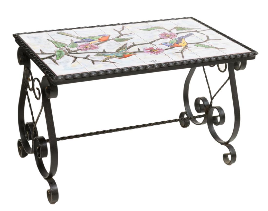 FRENCH WROUGHT IRON TILED COFFEE TABLE, SIGNED: French wrought iron coffee table, 20th c., having a ceramic tiled top with bird and foliate design, signed, rising on lyre shaped trestle base with scroll feet, approx 18.25"h, 29"w, 17.25"d Start Pri