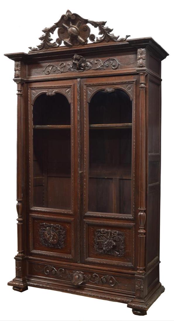 FRENCH LOUIS XVI STYLE DOUBLE DOOR BOOKCASE: French Louis XVI style bookcase, late 19th c., having a protruding cornice with foliate carved frieze above two doors, the upper part glazed the lower part with foliate carved panels, both open to adj
