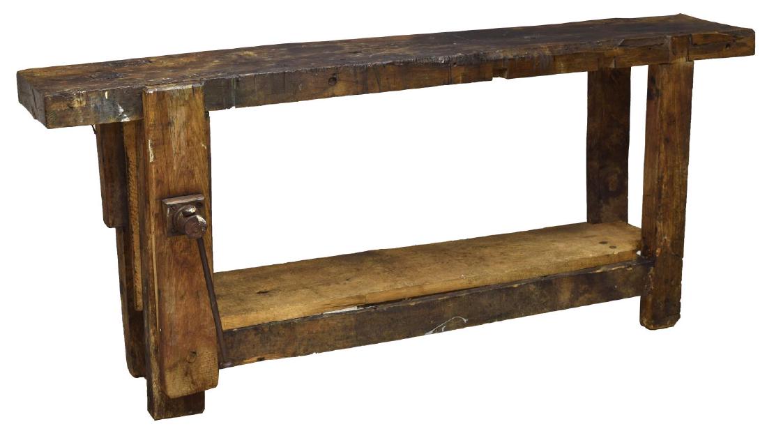 VINTAGE FRENCH WORK BENCH: Vintage beech wood work bench, early 20th c., an upper and lower shelf fitted at one side with a iron handle press, the center with a removable iron pry bar, rising on squared supports, mortise, tenon