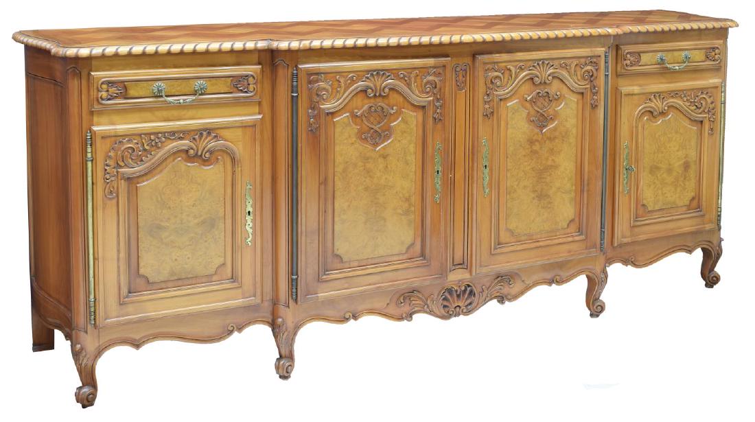 LOUIS XV STYLE CARVED FRUITWOOD/ELM SIDEBOARD: Louis XV style carved fruitwood and elm sideboard, early 20th c., the shaped top having parquetry design and rope molded edges, fitted with two short drawers and three cabinet doors with long metal hi