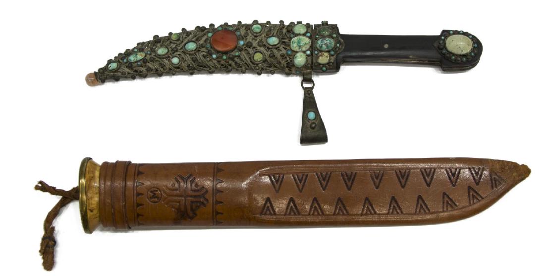 (2) FIXED BLADE KNIVES, TIBETAN & FINLAND: (lot of 2) Fixed blade knives: (1) Vintage Tibetan or Nepalese knife having a 6.5" blade with horn handle embellished with turqoise, the scabbard decorated with intricate metal work, turquoise and cor