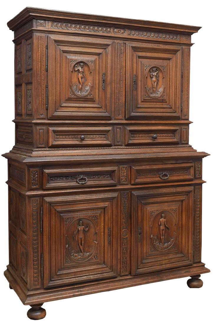 18th CENTURY CARVED FRENCH CUPBOARD: French Renaissance inspired 18th century two part cupboard, the upper part with two doors above two drawers, the lower part in similar configuration, the whole with figural carving at each door, the s