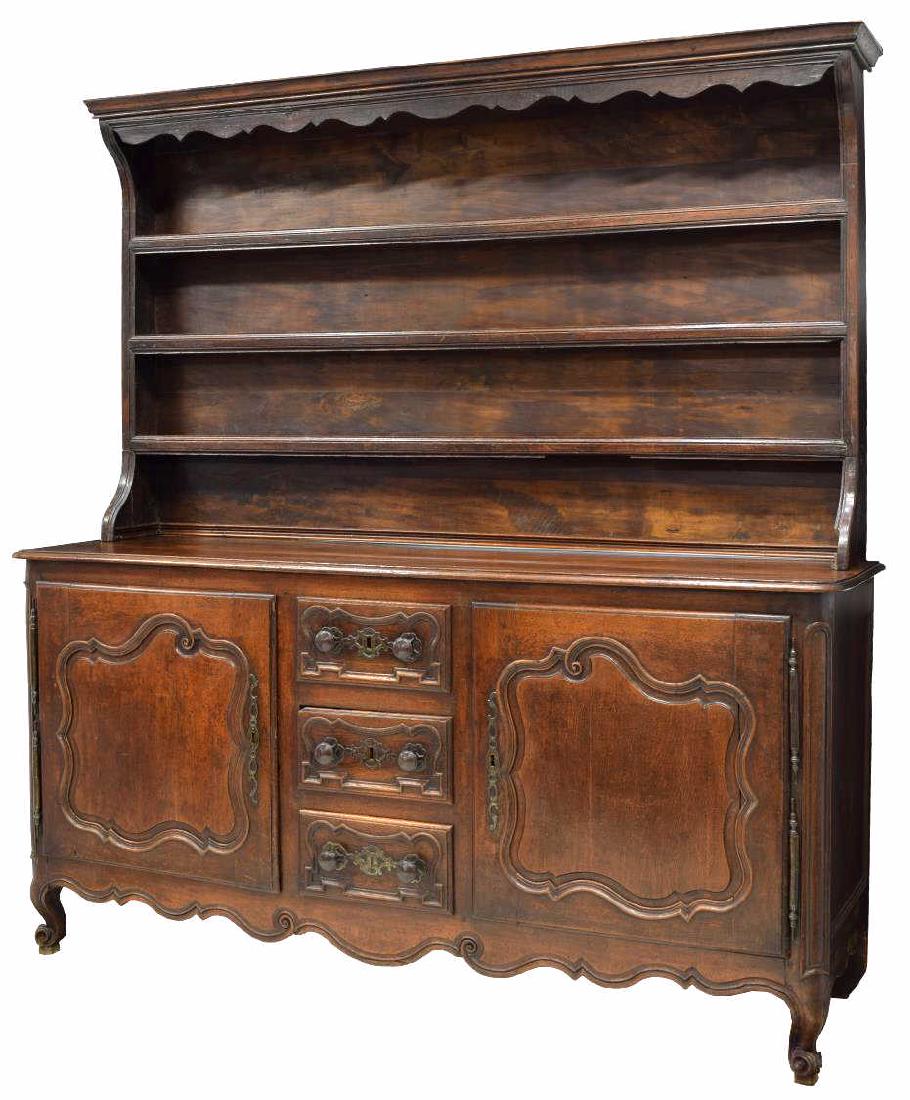 FRENCH LOUIS XV STYLE 19TH C. VAISSELIER: Louis XV style oak vaisselier,19th c., the upper part with a stepped and scalloped cornice above three display shelves, the rectangular work surface over three central drawers flanked at each side by 