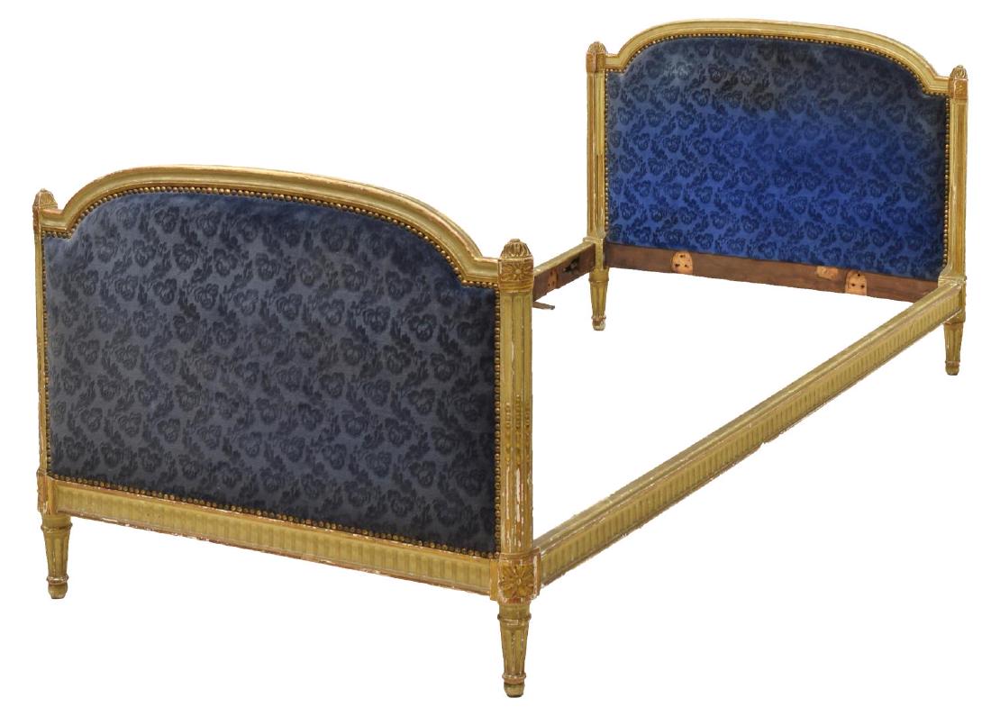 LOUIS XVI STYLE UPHOLSTERED GILT BED: Louis XVI style bed, 20th c., gilt painted frame, with upholstered head and footboards, accompanied by two bolster pillows in the same fabric, exterior: approx 32.25"h, 39.25"w, 78.25"d, interior: app