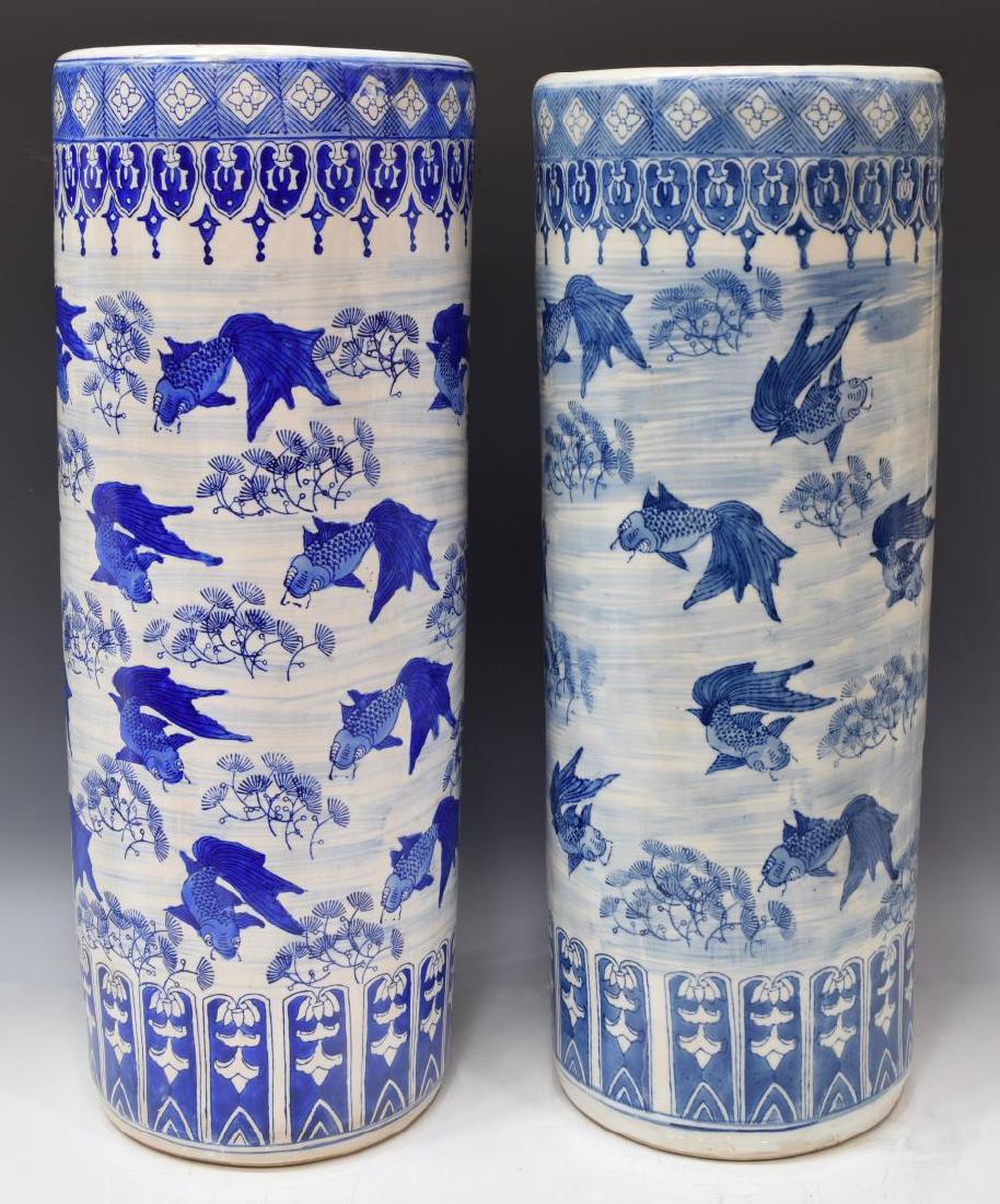 (2) CHINESE BLUE & WHITE PORCELAIN UMBRELLA STANDS: (lot of 2) Chinese blue & white porcelain umbrella stands, painted with fish and sea plant design signifying abundance, largest: approx 24.75"h, 9.5"diam; 32.5lbs Start Price: $125.00