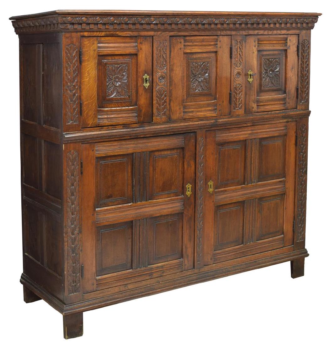 FRENCH RENAISSANCE REVIVAL CARVED CUPBOARD: French Renaissance Revival cupboard, last quarter 19th c., having a protruding cornice above the foliate carving, three upper doors with the center door appearing as a fixed panel but opening with a s