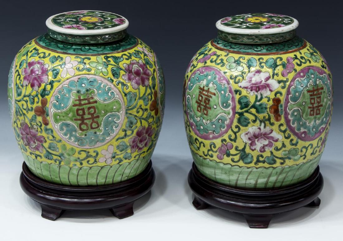 (2) FAMILLE-ROSE DOUBLE HAPPINESS GINGER JARS: (pair) Chinese famille-rose ginger jars, in floral pattern with double happiness characters, having and round lid over a globular body on a circular foot, red wax seal underfoot as pictured, accompani