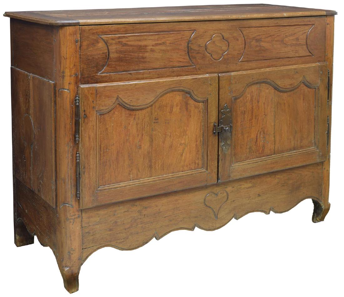 18TH CENTURY FRENCH OAK BUFFET: French oak buffet, 18th c. having an incised quatrefoil and heart decoration, the hinged top opens to shallow storage above two doors with iron hardware, rising on cabriole legs, 43.5"h, 57"w, 24.5"d 