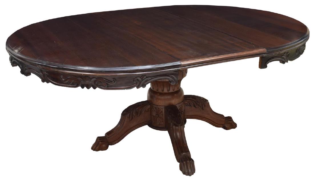 GOTHIC REVIVAL STYLE CARVED MAHOGANY DINING TABLE: Gothic revival style carved mahogany dining table, c. 1880's, the round top rising on an acanthus accented pedestal base issuing four claw-and-ball foot spider legs, accompanied by matching leaf, appr