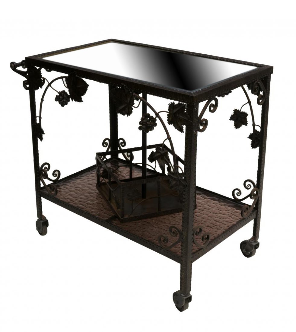 FRENCH WROUGHT IRON MIRRORED TOP SERVICE CART: French wrought iron service cart, 19th c., with mirrored top over base with pierced grape vine design, tinted wave glass bottom tier fitted with lazy susan , rising on caster feet, approx 29"h, 34"l,