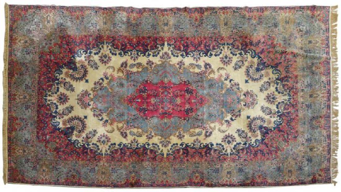 PERSIAN HAND TIED LAVAR KERMAN RUG, 16'3"x9'8": Persian hand tied Lavar Kerman rug, c. 1930, decorated with blooming branches and foliated motif, executed in pink, blue, white and brown tones, some stains, discoloration, minor hole, approx 16'3"l, 