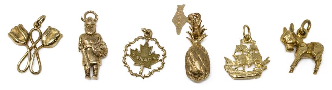 (6) LADIES ESTATE 14KT GOLD SOUVENIR CHARMS: (lot of 6) Ladies estate 14kt gold charms, including: (1) Hawaiian pineapple, (1) Viking figure, (1) donkey, (1) tulips with looped stems, (1) Canadian maple leaf, (1) pirate ship; largest: approx 1"h