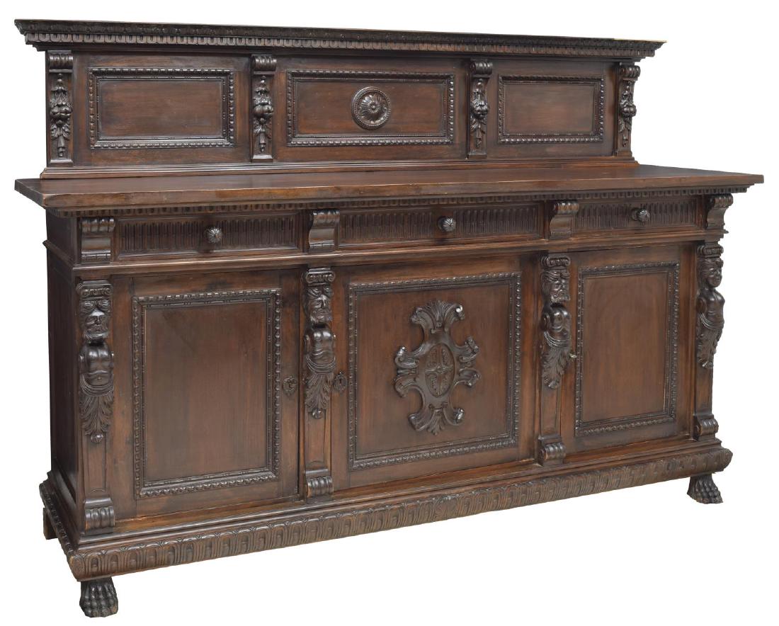 RENAISSANCE REVIVAL FIGURAL CARVED SIDEBOARD: Heavily carved Renaissance Revival mahogany finish sideboard, early 20th c., having a heavily carved and molded back board with foliate accents and floriform reserve to center, the rectangular work su