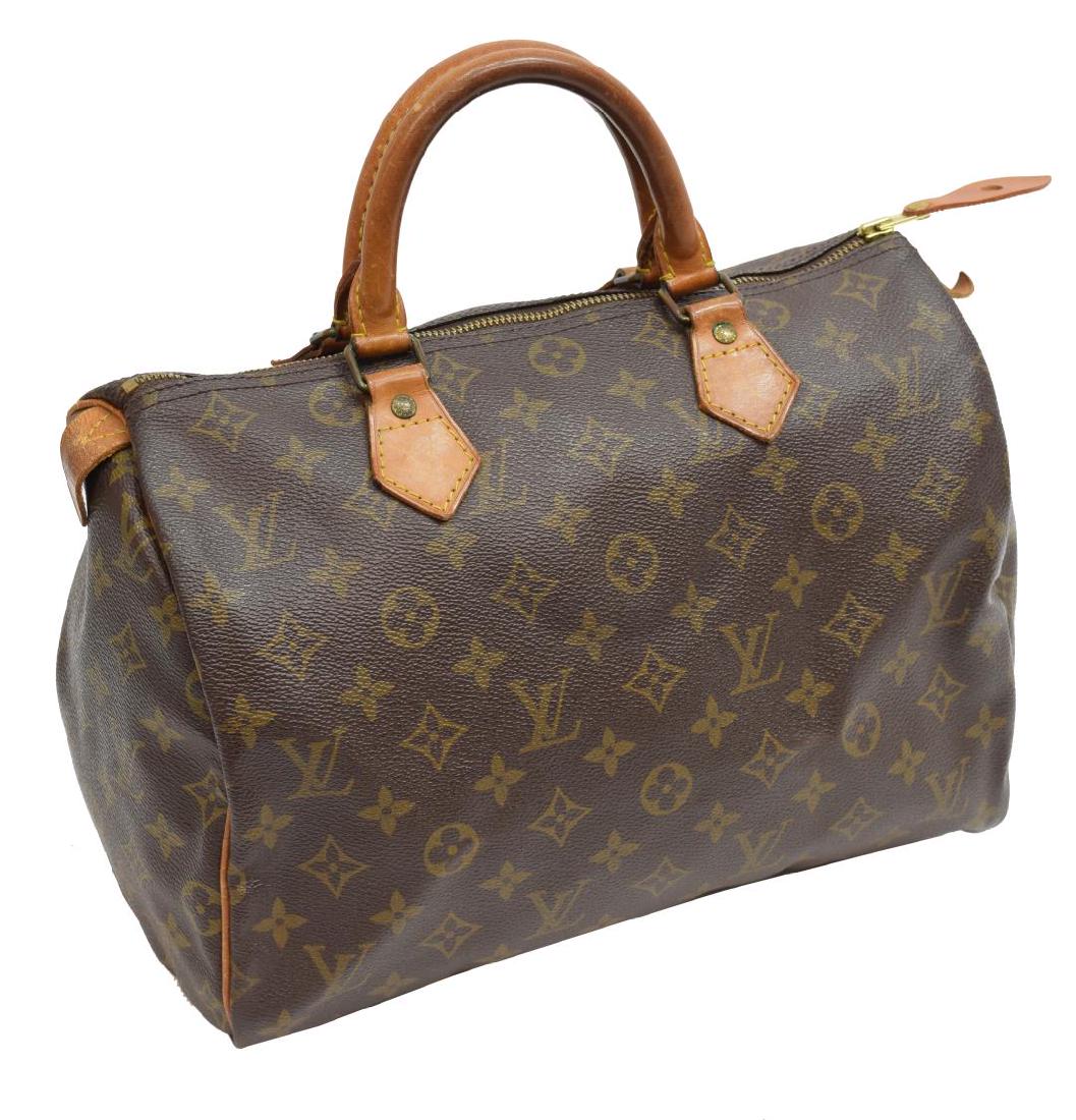 LOUIS VUITTON 'SPEEDY' MONOGRAM CANVAS HANDBAG: Louis Vuitton "Speedy" handbag, in brown and tan monogram coated canvas, with brass hardware, tan vachetta leather trim, dual rolled top handles, brown canvas lining, single slit pocket at interior wa