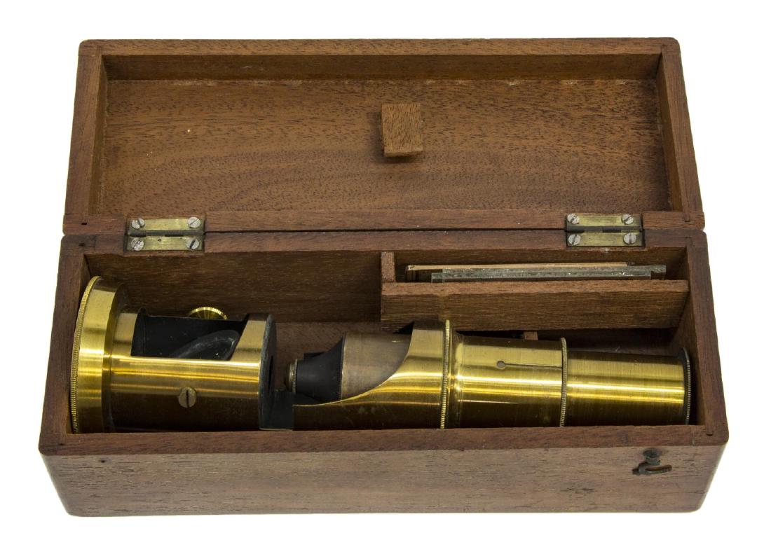 ANTIQUE BRASS FIELD MICROSCOPE, WOOD BOX, SLIDE: Antique brass field microscope housed in wood box, 19th c., with one slide, the name written in French, wood box: 2.25"h, 6.75, 1lb Start Price: $60.00
