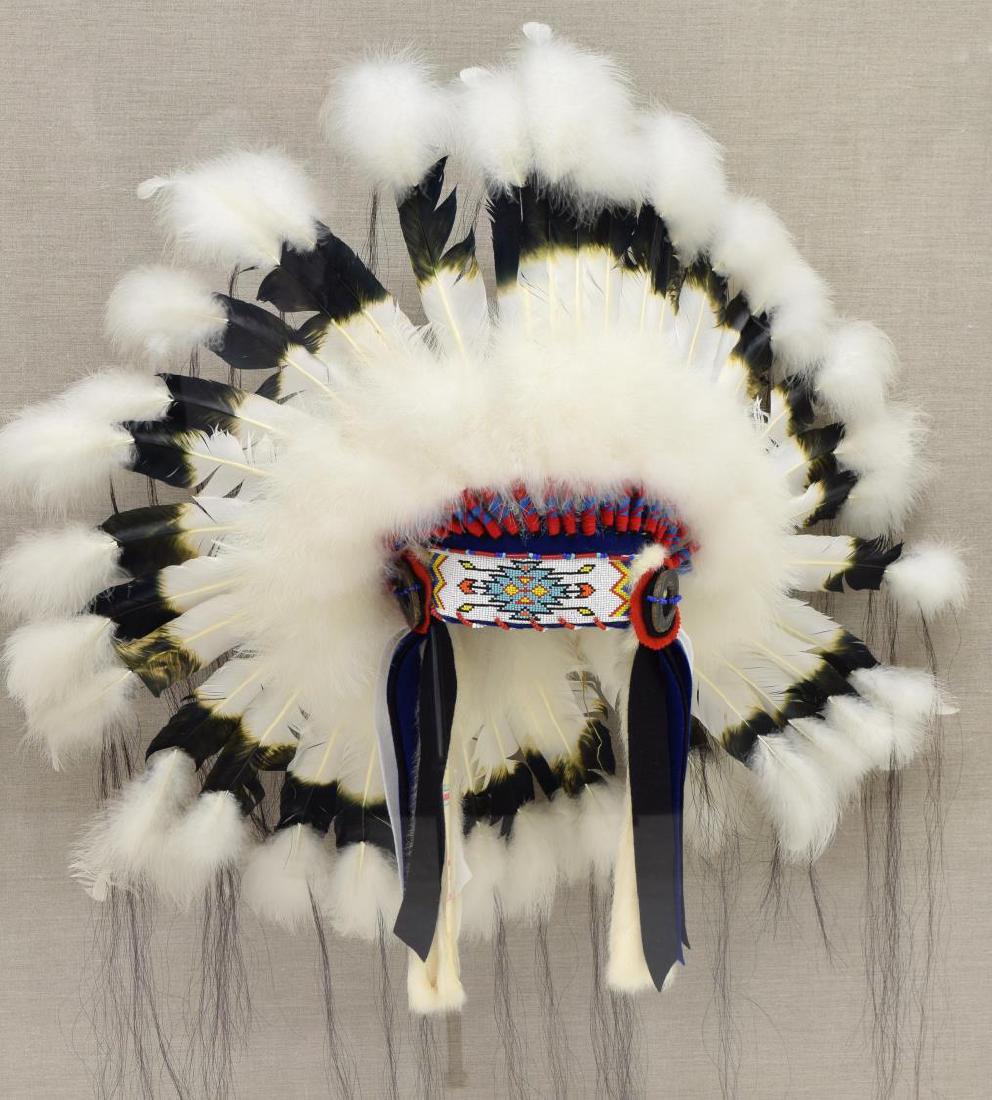 DECORATIVE NATIVE AMERICAN HEADDRESS IN PLEXI CASE: Decorative Native American war bonnet headdress, fashioned with a polychrome beaded brow band and dyed feathers, presented in plexiglass case with linen backboard, overall: approx 52.25"h, 39"w, 24"d