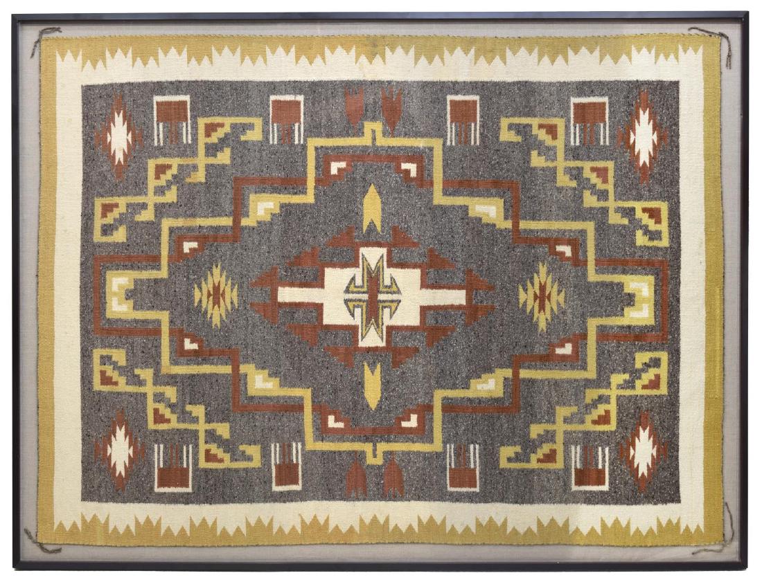 FRAMED NAVAJO BURNTWATER WOVEN RUG: Framed Navajo Burntwater hand spun wool rug, Northeast Arizona, with ochre and creme border, centering grey ground with central diamond design, rug: approx 69"l, 51.25"w, frame: approx 74.75"l, 56.75"