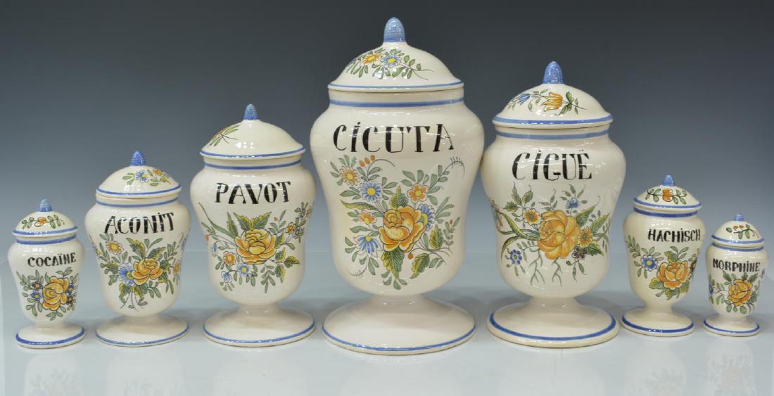 (7) FRENCH MEILLONNAS FAIENCE APOTHECARY JARS: (lot of 7) French Meillonnas faience apothecary jars, 20th c., glazed white ground, with polychrome flowers, rising on circular foot, largest: approx 12"h, 6"diam; 8.25lbs total Start Price: $80.00