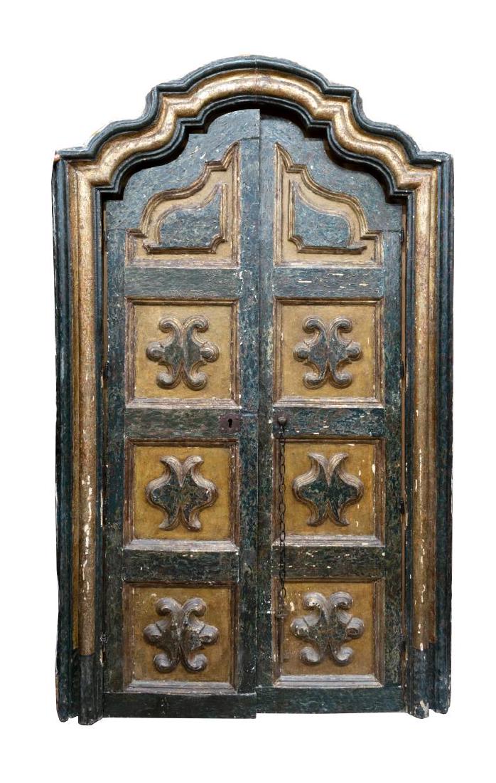 ANTIQUE ARCHITECTURAL SPANISH BAROQUE STYLE DOORS: Spanish Baroque style architectural doors and frame, early 19th c., the shaped frame parcel gilt and in green crackled paint, enclosing doors of conforming form, each paneled with raised carved embell
