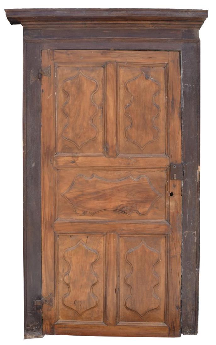 ITALIAN ARCHITECTURAL MONASTERY WALNUT DOOR: Italian architectural monastery walnut door, 18th c., having frame with cornice top, fitted with paneled door, wear, splits to boards, losses to frame, approx 90.25"h, 51"w, 6"d Start Price: $600.00