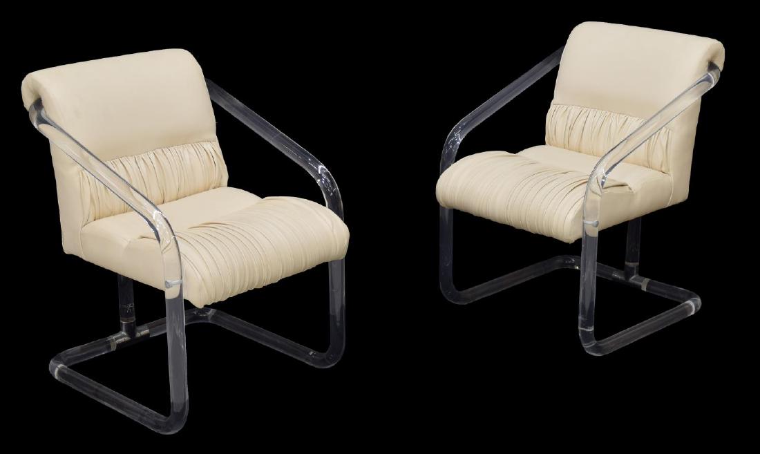(2)MODERN 'LION IN FROST' ACRYLIC & LEATHER CHAIRS: (lot of 2) Modern tubular acrylic framed arm chairs, design by Leon Frost for Lion in Frost Furniture Inc., 1979, signed at the back support, upholstered in cream color rolled and pleated leather, sig
