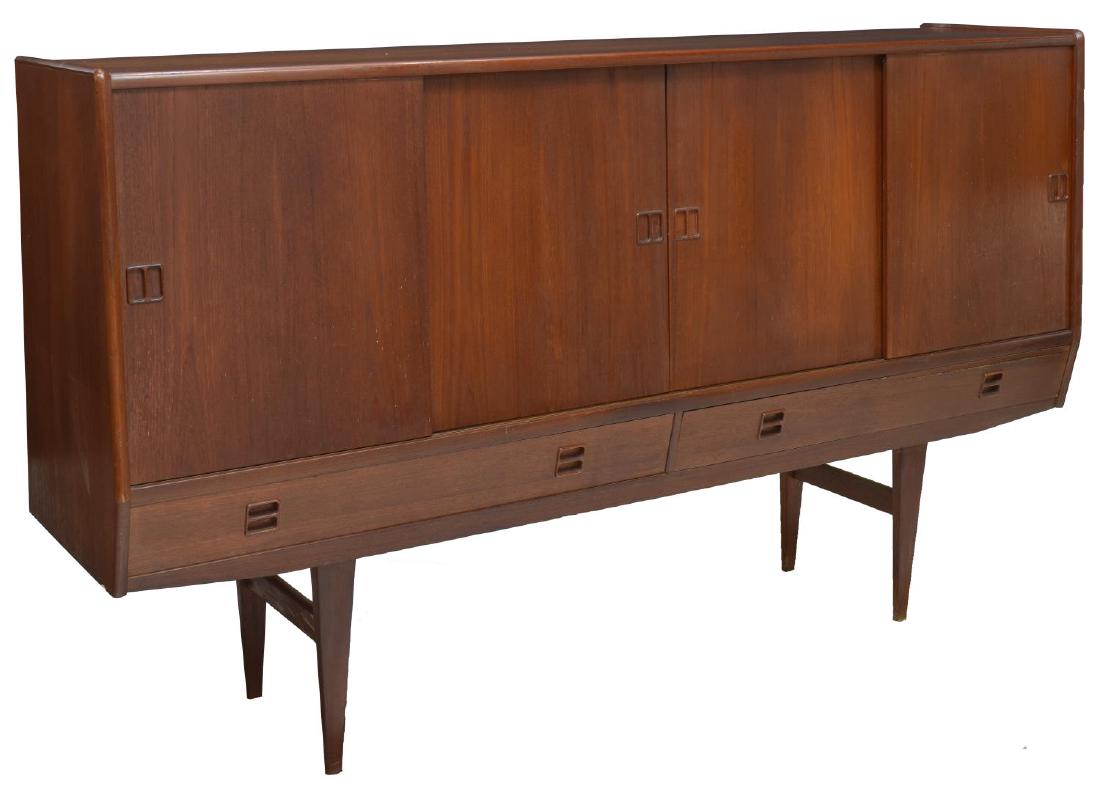 DANISH MID-CENTURY MODERN TEAKWOOD BAR SIDEBOARD: Danish mid-century modern teak sideboard, c. 1950s, multiple sliding doors open to interior with mirror back bar area, pull out drawers, and long shelves to the other side, above two slim drawers, on 