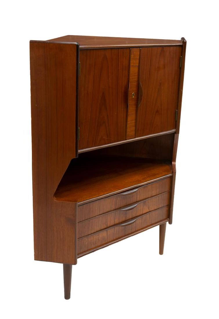 DANISH MID-CENTURY MODERN TEAKWOOD CABINET / BAR: Danish mid-century modern teak corner cabinet / bar, c. 1950s, two upper doors open to mirrored and shelved interior, over open center, three drawers below rise on cylindrical legs, approx 48"h, 35"w,