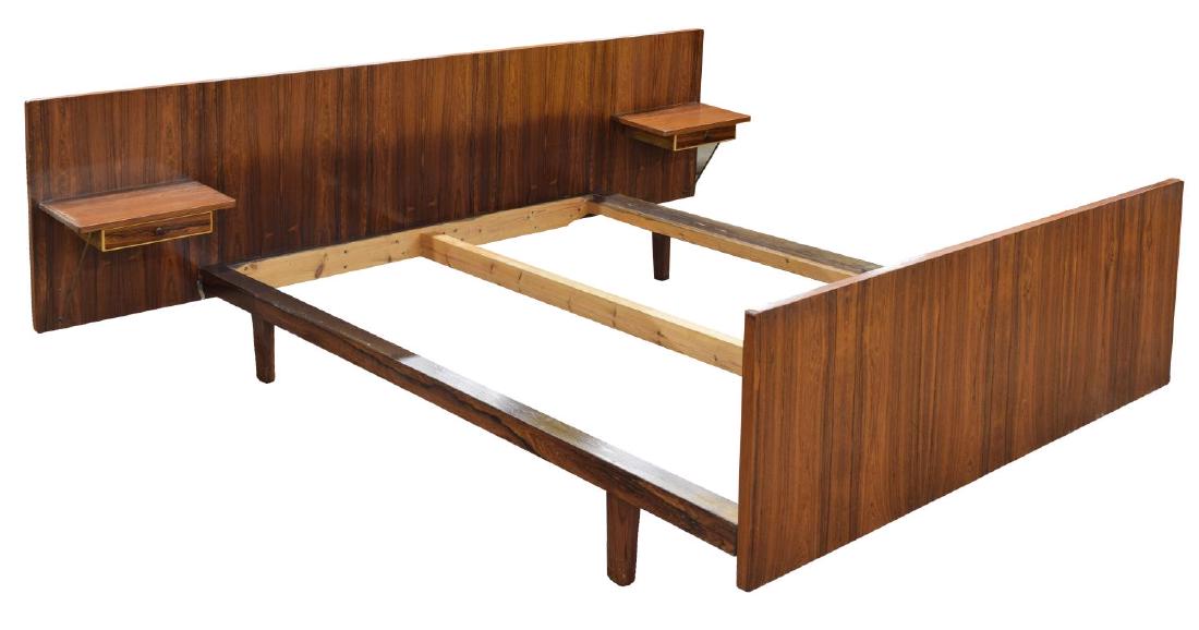 DANISH MID-CENTURY MODERN ROSEWOOD BED: Danish mid-century modern rosewood bed, c. 1960s, the long headboard having integral shelf to either side, above a small drawer, platform support, ending in a footboard, overall: approx 89.75"l, 76"w,