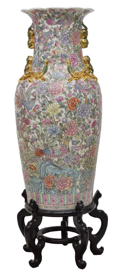 LARGE CHINESE FAMILLE ROSE PARCEL GILT VASE: Large Chinese famille rose porcelain parcel gilt vase on stand, the scalloped flared rim over a long neck accented with applied gilt foo dogs and salamanders, tapered body with floral and bird design,