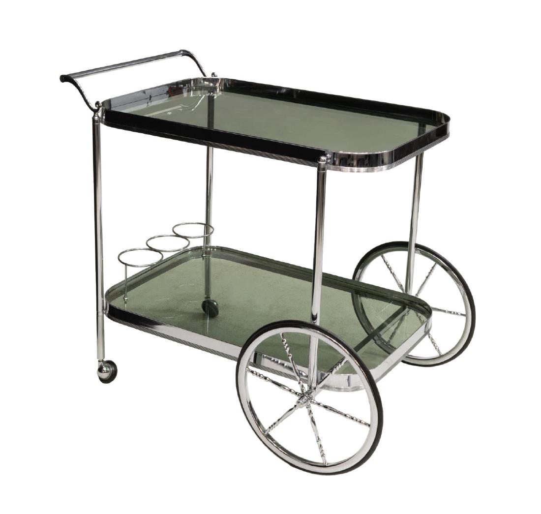FRENCH MODERN CHROMED STEEL & GLASS SERVICE CART: French modern chromed steel service cart, two tiers having smoked glass, the lower with bottle storage, moving on spoked front wheels and castors, approx 28"h, 30"w, 18"d Start Price: $80.00