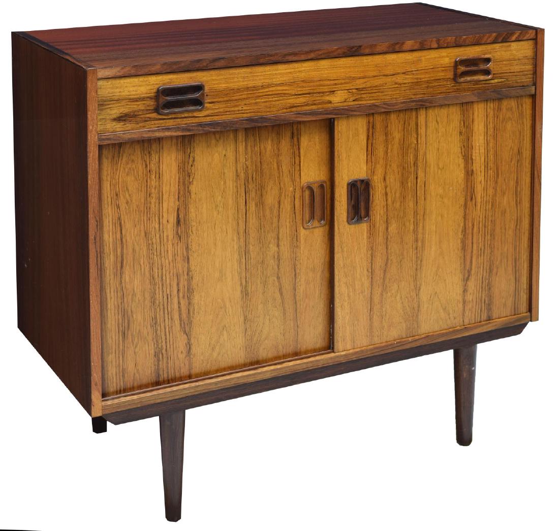 DANISH MID-CENTURY MODERN ROSEWOOD SIDEBOARD: Diminutive Danish mid-century modern rosewood sideboard, c. 1960s, having a long single drawer, over cabinet base opening to a shelf, on cylindrical legs, variation to finish, approx 31.5"h, 34.25"w,