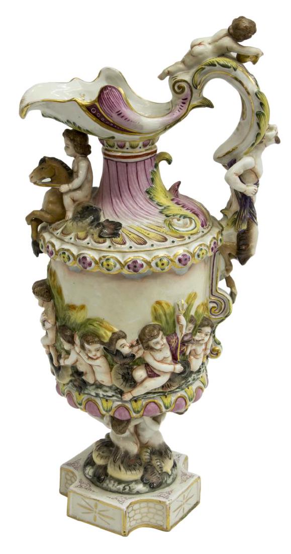CAPODIMONTE PORCELAIN PUTTI & SATYR EWER: Capodimonte porcelain ewer fronted by a nude putto on the back of a hippocamp, 19th c., rocaille waterside scenes with putti in relief and stylized dolphins, satyr form handle surmounted by a putto, s