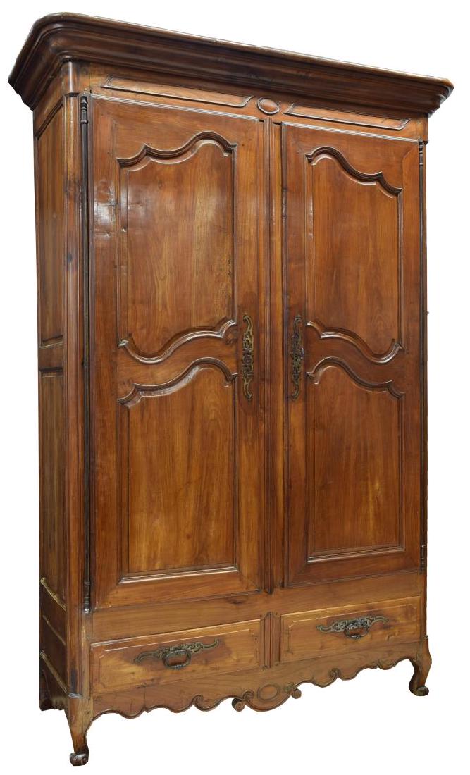 LOUIS XV FRUITWOOD ARMOIRE, 18TH C.: Louis XV fruitwood armoire, c. 1780, having a protruding cornice over two paneled doors hung on long exterior hinges above two lower drawers, all rising on scroll foot cabriole legs, 96"h, 64"w, 26"d 