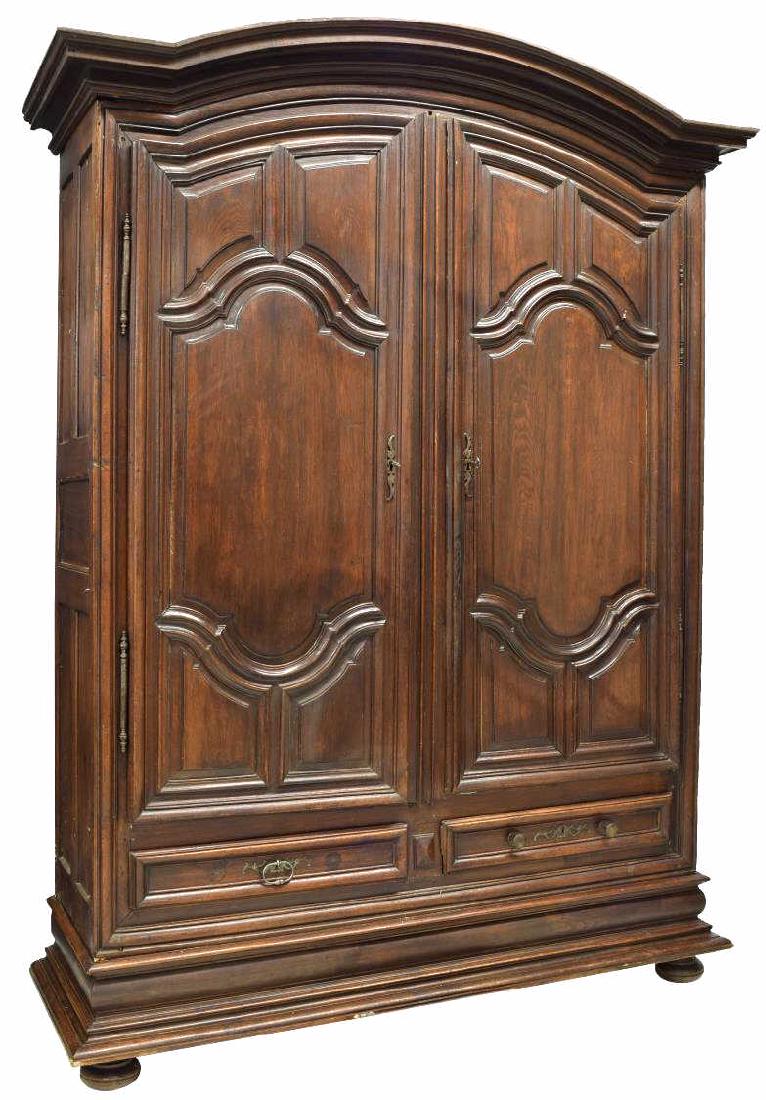 MONUMENTAL FRENCH LOUIS XIV STYLE OAK ARMOIRE: French Louis XIV style oak armoire, late 18th/ early 19th c., with arched cornice top, case fitted with paneled double-doors, opening to shelves, over two drawers, plinth base, rising on bun feet, one