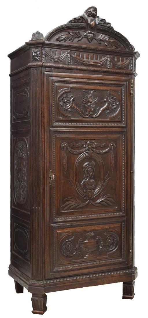 FINELY CARVED LOUIS XVI MID 19TH C. BONNETIERE: French Louis XVI style highly carved bonnetiere, mid 19th c., an arched cornice above the single door with floral and figural carving and hung on a long exposed hinge with acorn finial, the interior w