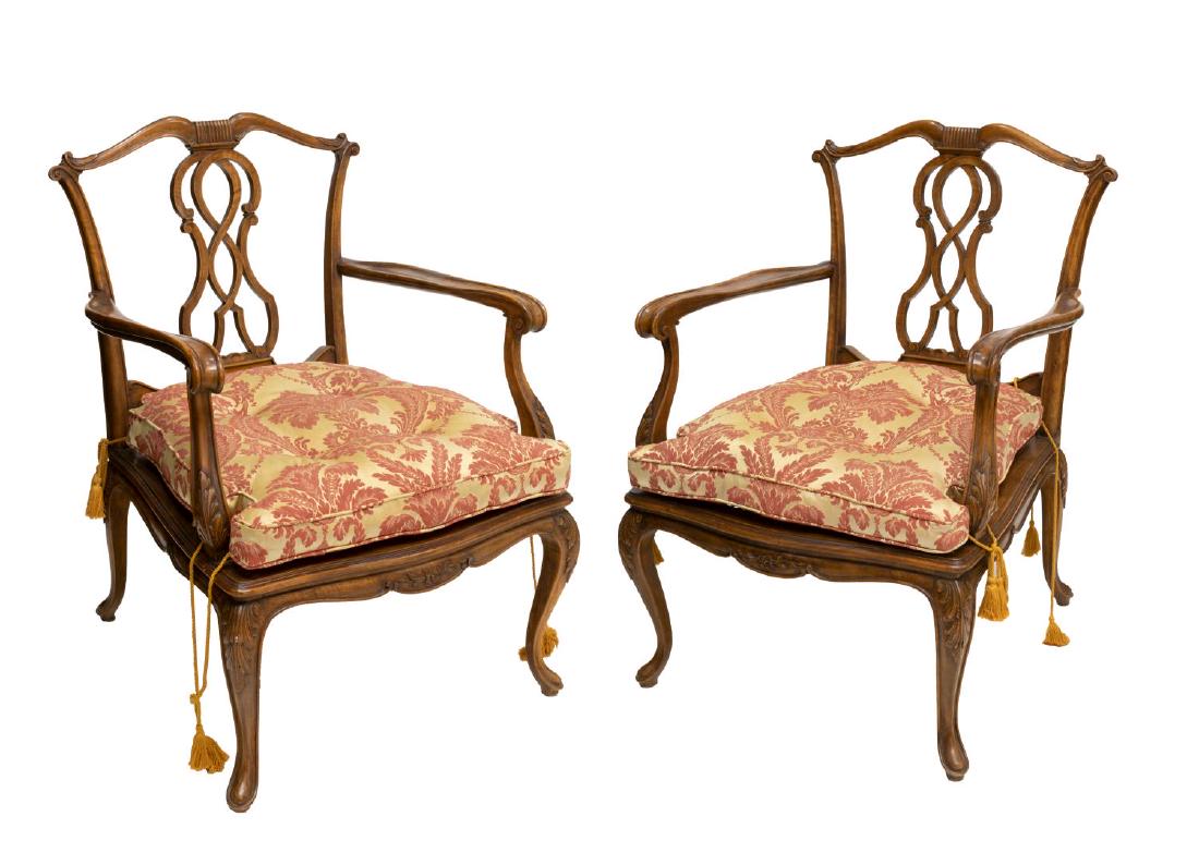 (2) VENETIAN CARVED WALNUT CANE SEAT ARMCHAIRS: (pair) Venetian walnut arm chairs, 20thc., each having open work splat, over scrolled arms, caned seat on carved legs, accompanied by buttoned cushion, approx 34"h, 24"w, 22.5"d Start Price: $150.00