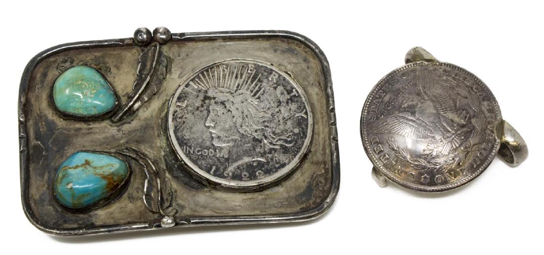 (2) SOUTHWEST STERLING SILVER DOLLAR BELT BUCKLES: (lot of 2) Silver belt buckles: (1) Native American sterling buckle, set with turquoise cabochons and a 1922 Peace silver dollar, approx 2.25"h, 3.25"w; (1) fashioned from a 1921 Morgan silver dollar,