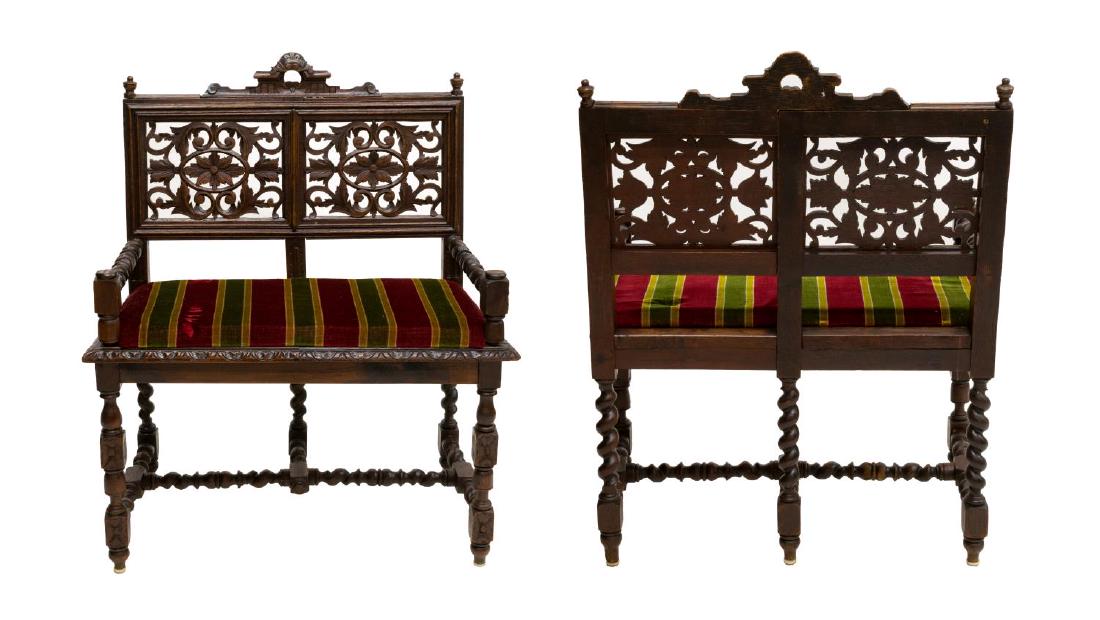 2) ENGLISH SPIRALED OAK & UPHOLSTERED HALL BENCHES: (pair) Diminutive English oak hall benches, 20thc., each having foliated crest, over pierced floral carved panels (one replaced), padded seat in striped upholstery, rising on a spiraled stretcher base