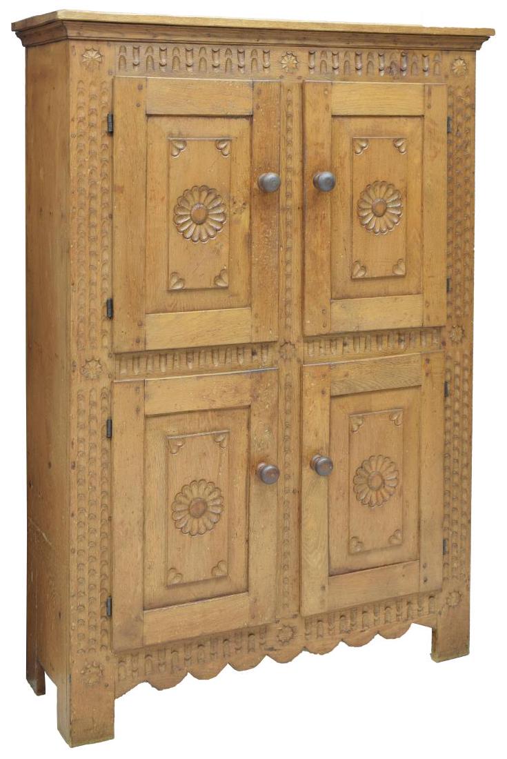 DUTCH PRIMITIVE CARVED OAK FOUR-DOOR CABINET: Dutch oak cabinet, having cornice top, over dual stacked double-door cabinets, opening to shelves, cabinet doors and case with decorative carving, scalloped apron, rising on bracket feet, approx 61"h,
