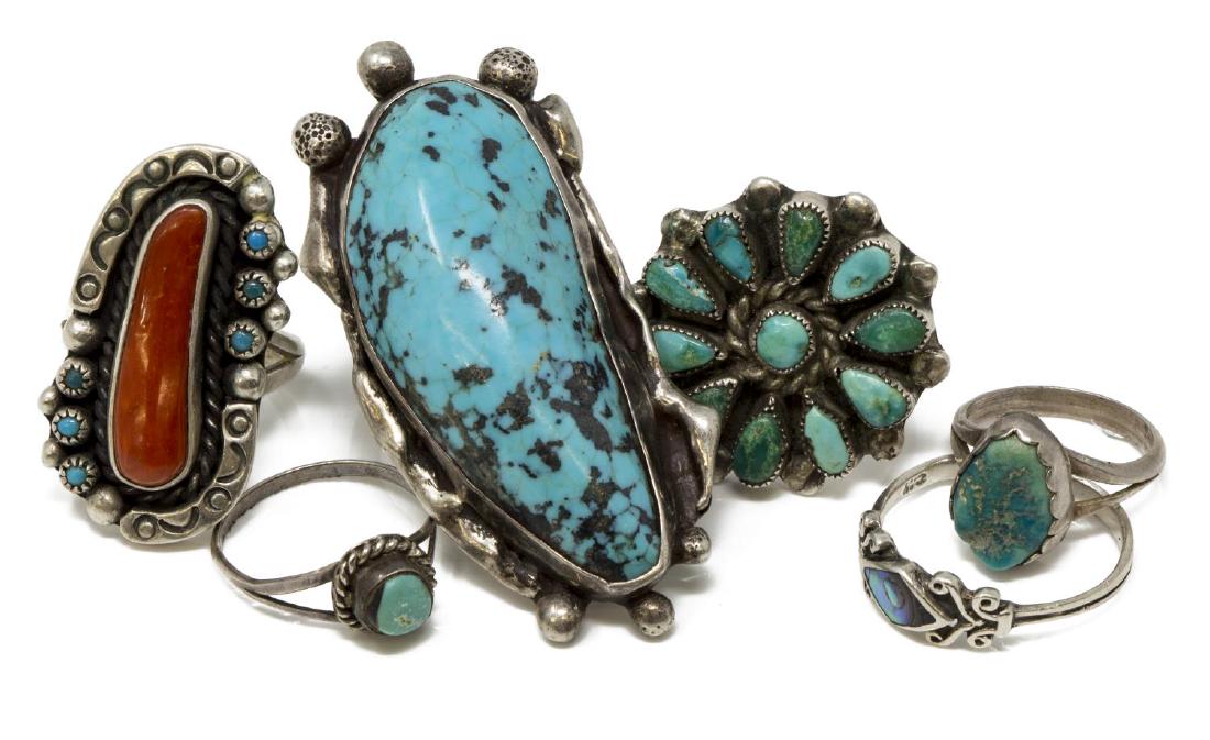 (6) VINTAGE NATIVE AMERICAN TURQUOISE SILVER RINGS: (lot of 6) Vintage Southwest silver tone rings, some set with turquoise, coral and abalone, the largest with shaped turquoise initialed IT?, one signed DB, Zuni, one with bent shank, sizes range from