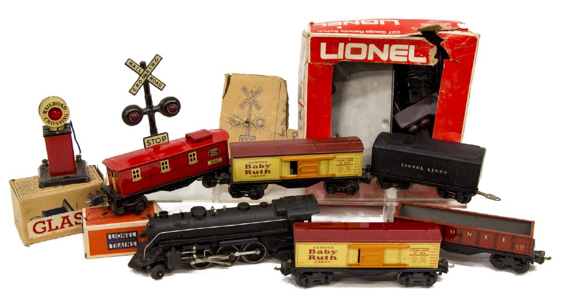 (11) LIONEL TRAIN GROUP: (lot of 11) Lionel Train group: (1) locomotive #1666; (1) tender car #2989W; (1) freight car #2677; (1) Ruth car #1679; (1) Baby Ruth car #2679; (1) caboose #2682; (2) remote control switch #5121, #51