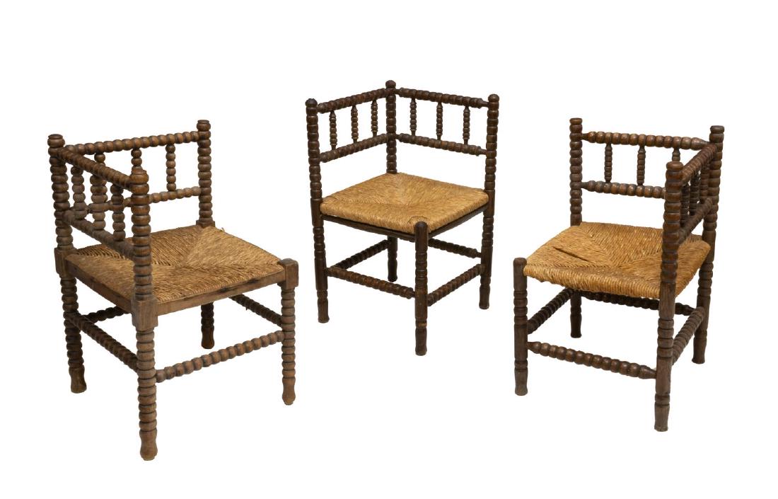 (3) ENGLISH TURNED OAK CORNER CHAIRS: (lot of 3) English oak corner chairs, having turned frames with slat back, over rush seat, rising on turned legs joined by a box stretcher, approx 27"h, 17"w, 17"d Start Price: $60.00