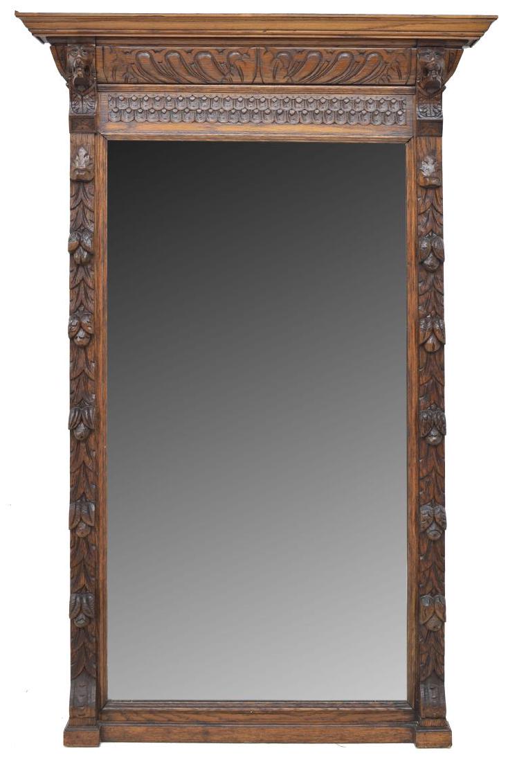 FRENCH LION MASK CARVED OAK WALL MIRROR: French carved oak wall mirror, 19thc., an overhang cornice, surmounting carved lion masks and foliate pendants in relief, flat mirror plate, approx 64.25"h, 41"w Start Price: $100.00