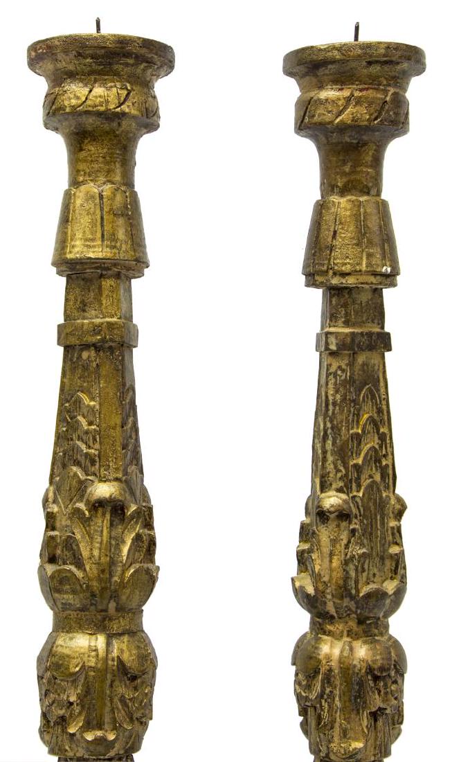 (PAIR) GILTWOOD ALTAR CANDLE PRICKETS: (pair) Giltwood altar candle prickets, with carved acanthus leaf accents to standard, over tripartite base, rising on paw feet, approx 30.25"h, 7.5"diam; 10lbs total Start Price: $100.00